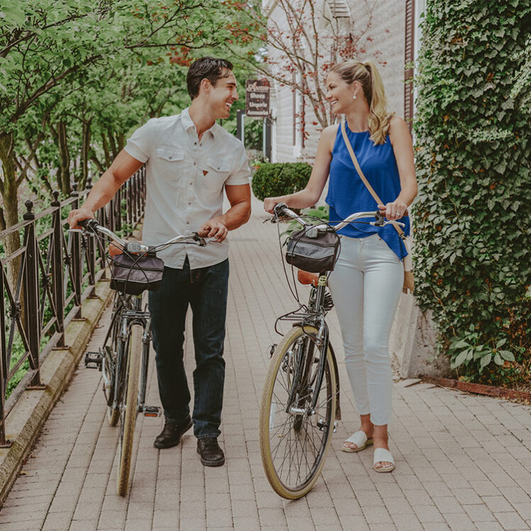 Couple indulging in bike rental services at Inn On The Twenty in Jordan Village