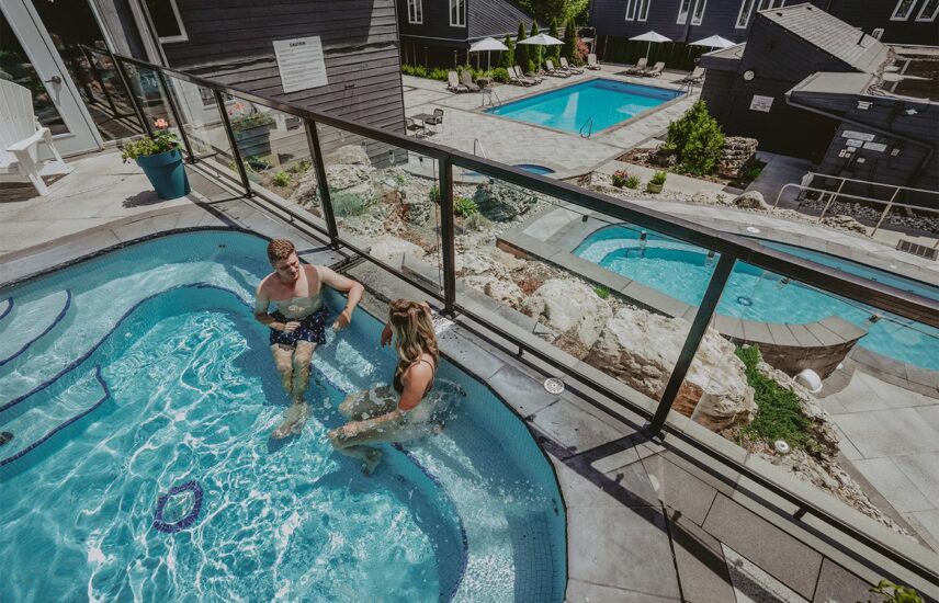 Couple lounging in outdoor pool at Millcroft Inn & Spa in Caledon