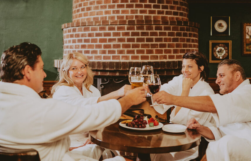 Friends toasting to good times at the Vintage Wine Bar & Lounge at the Pillar & Post in Niagara-on-the-Lake