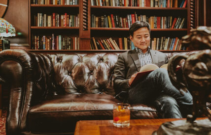 Guest enjoying the Queen's Landing library during their stay in Niagara-on-the-Lake